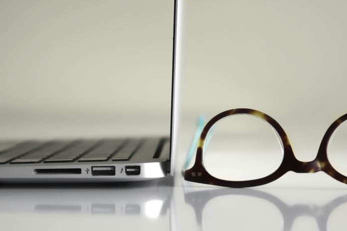 glasses next to laptop