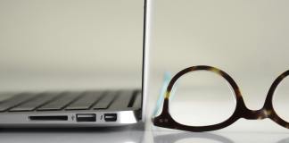 glasses next to laptop